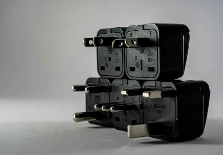 Stos wtyczek elektrycznych, symbolizujący brak jednej fazy w domu.